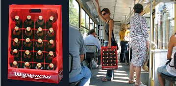 Woman carries crate of beer