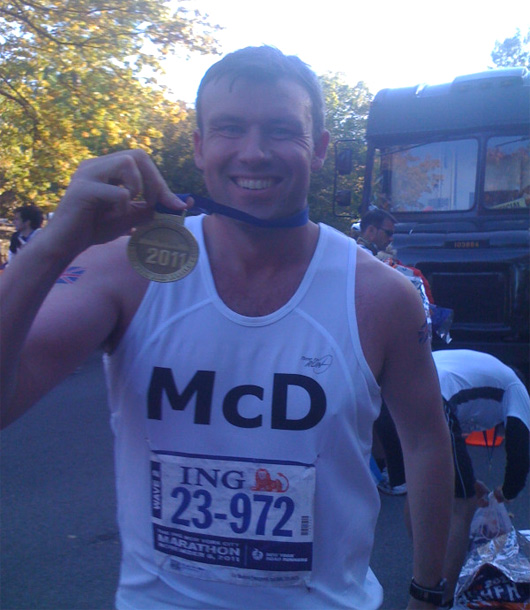 Mark wearing a medal and a running vest with McD on it